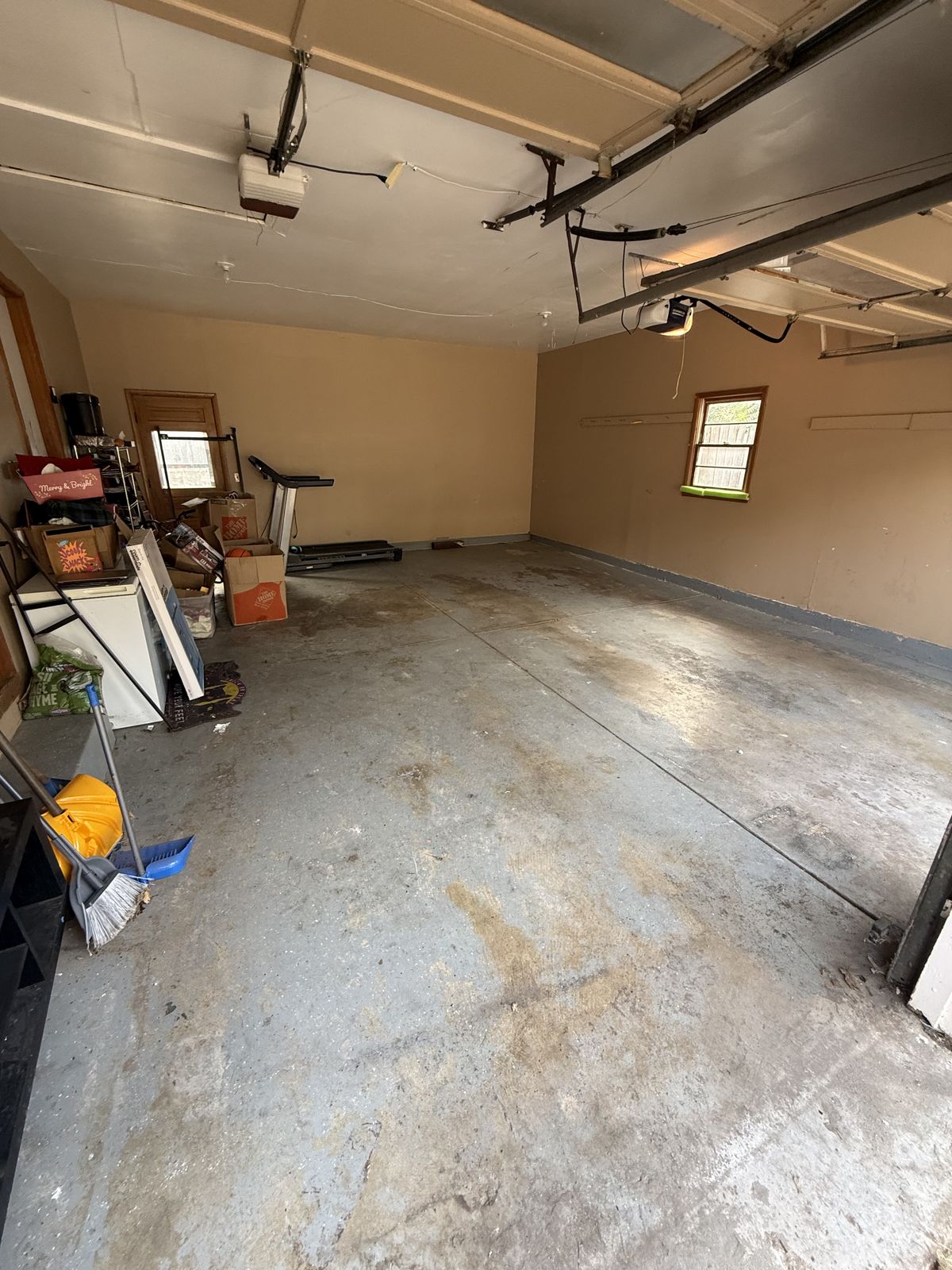 A two-car garage nearly empty after a cleanout
